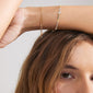 Close-up of the PIXIE gift set: two gold-plated bracelets, featuring a classic box chain and a beaded bracelet with grey agate and glass beads.